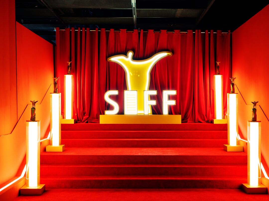 Silhouette of a photographer with a long lens at a red carpet event