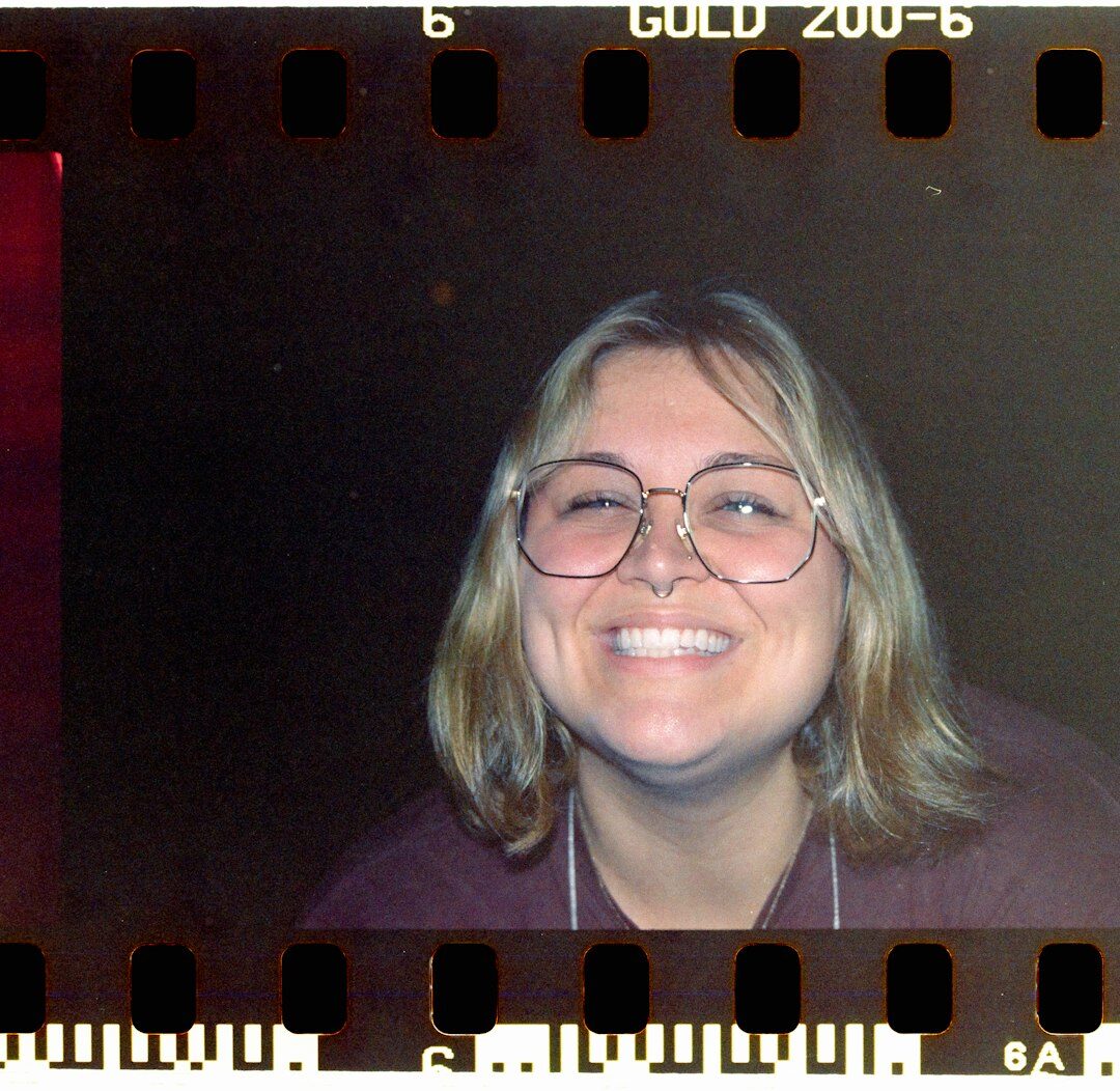 Portrait of a senior female editor with short dark hair and glasses