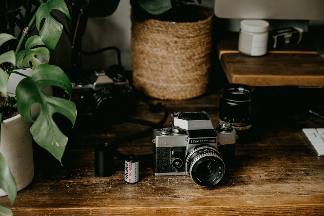 Vintage film camera and reels resting on a wooden production desk