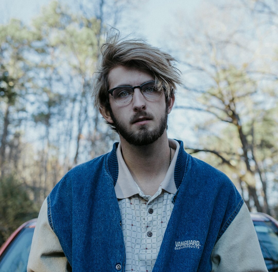 Portrait of a male culture editor with short beard in a knit sweater